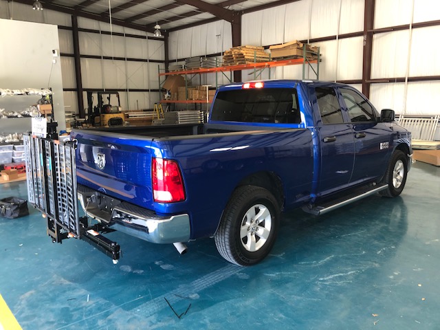 Closed Up Vehicle Lift on Blue Truck