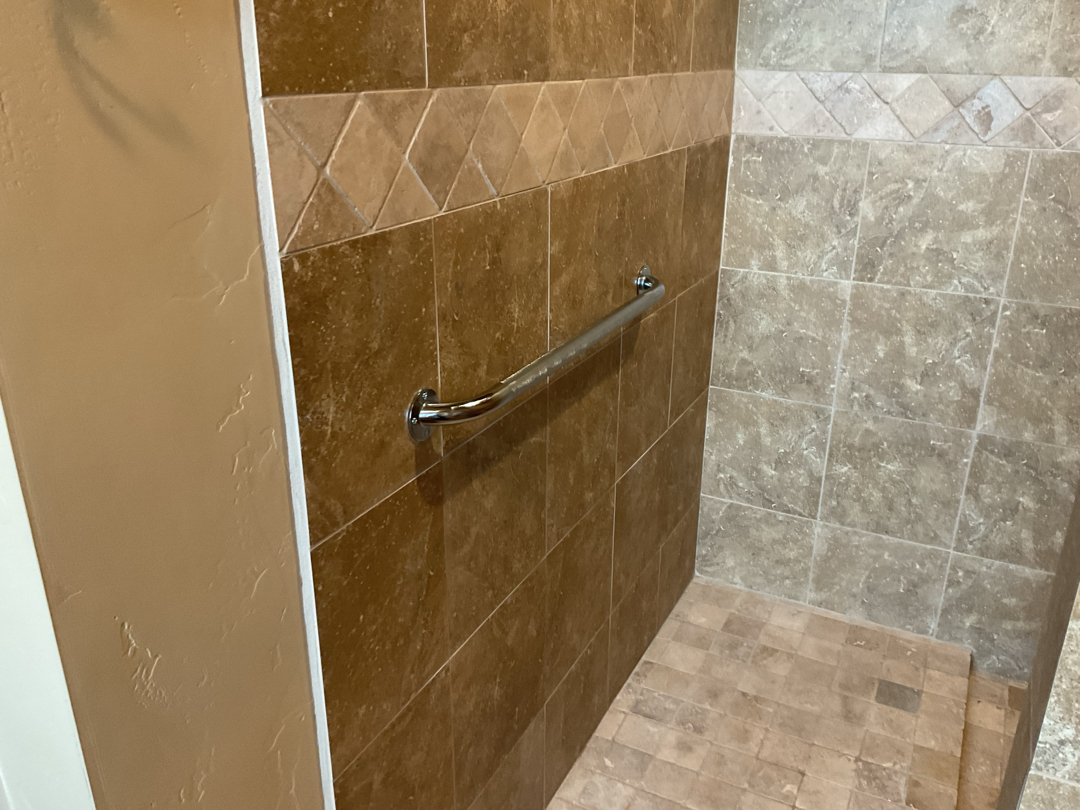 Grab bar in tile shower