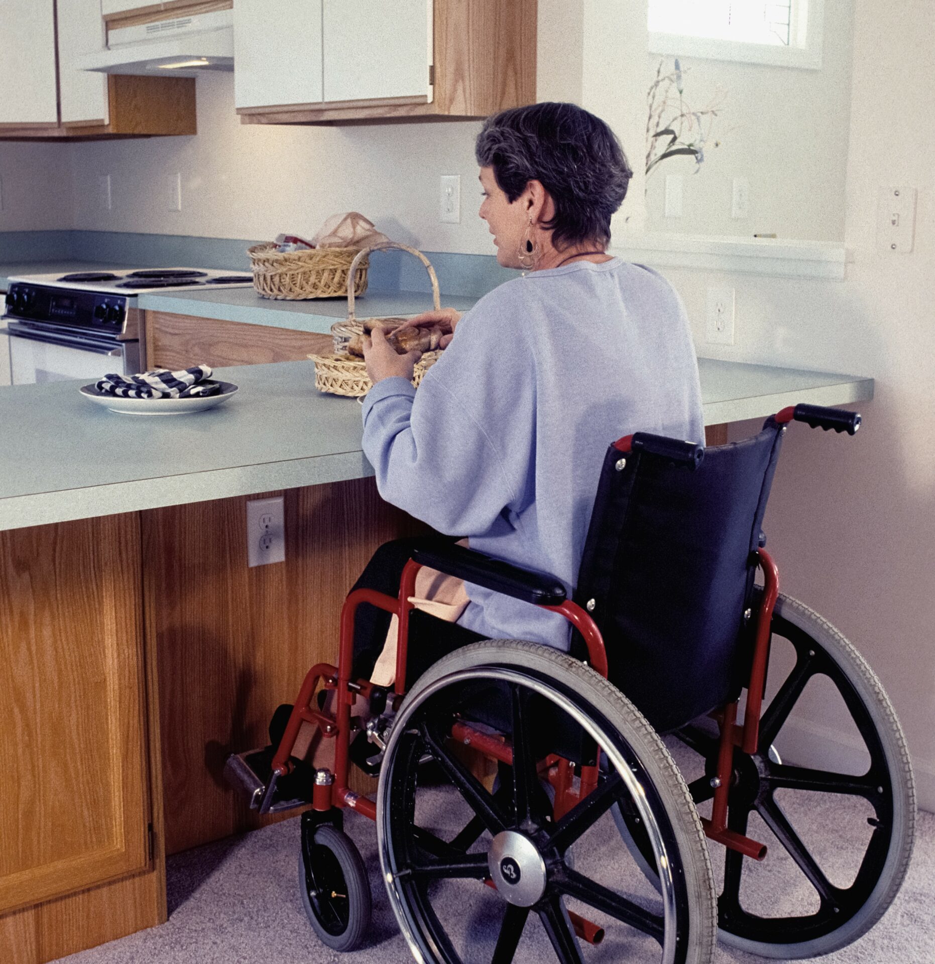 Lady in wheelchair at kitchen counter
